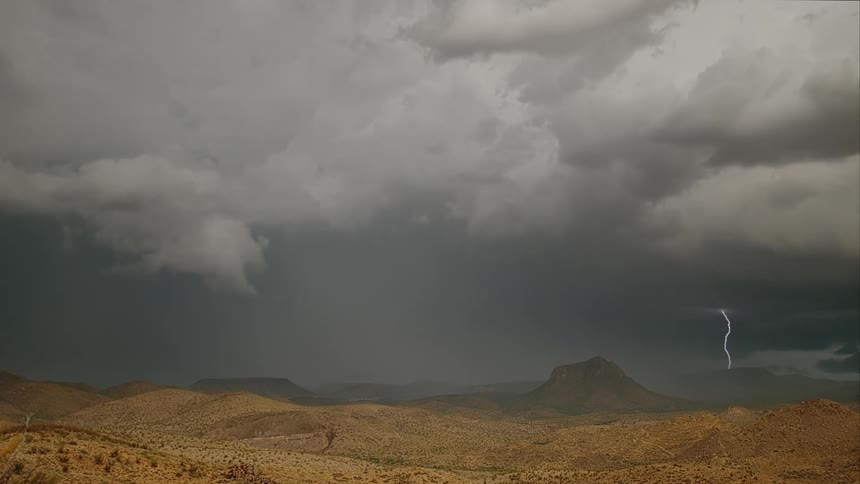 Its storming with lightning in a valley landscape
