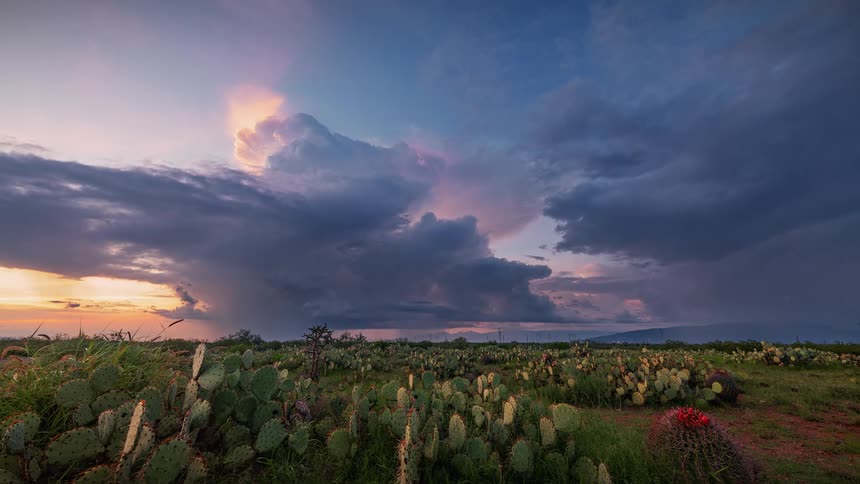 Storm clouds flow over the desert