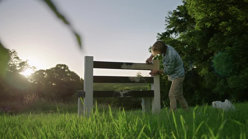 A man working on a fence