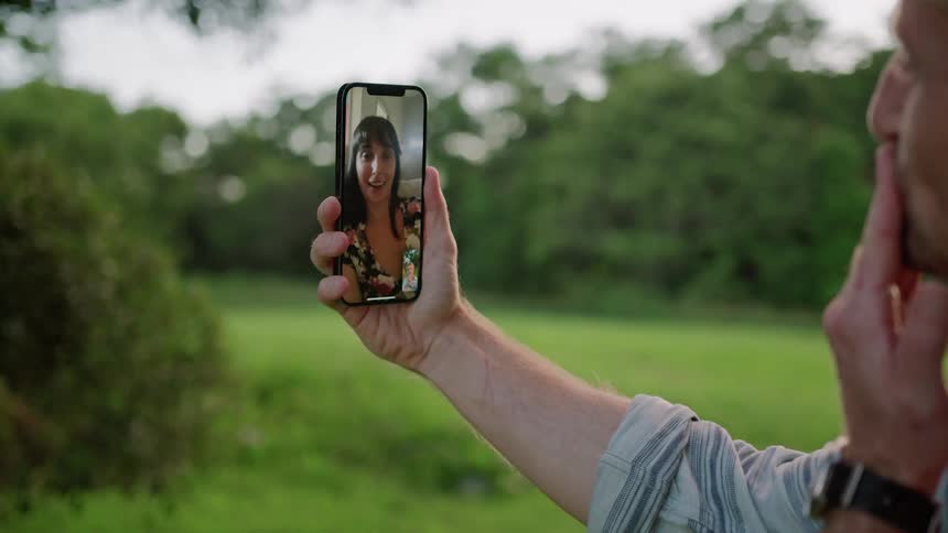 A view of two people talking on a smartphone
