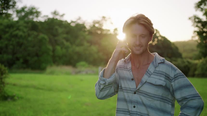 A man talking on a smartphone outside