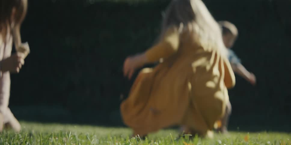 Children eat ice cream in the grass