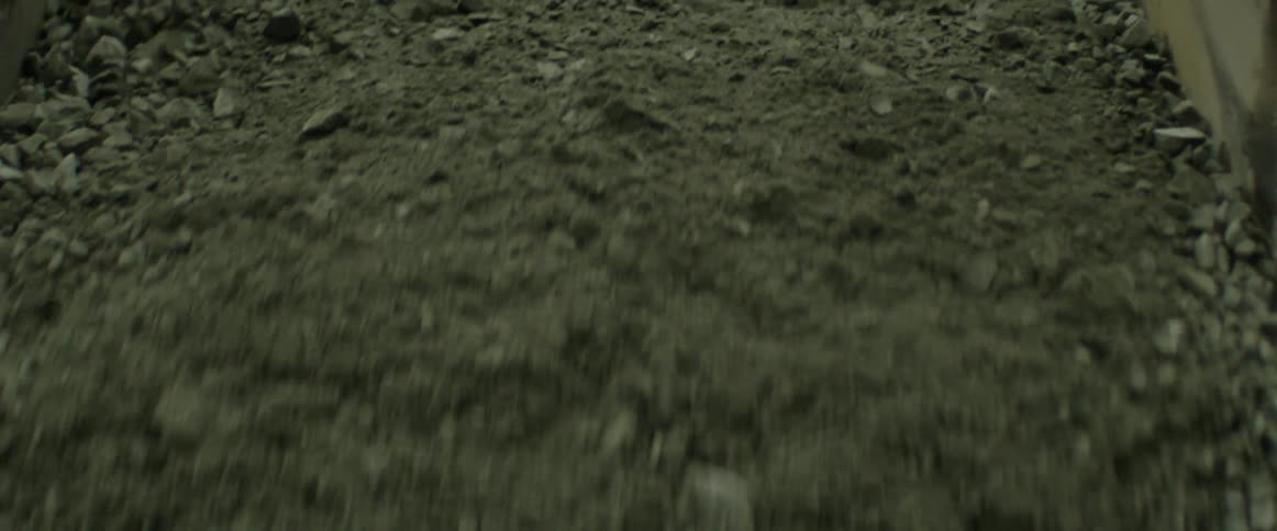 Dirt falling out of the back of a dump truck