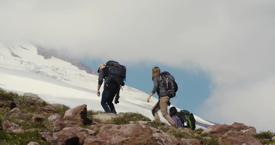 A group of friends are rock climbing a mountain together