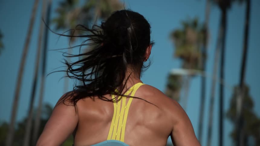 A woman is jogging outdoors during the daytime