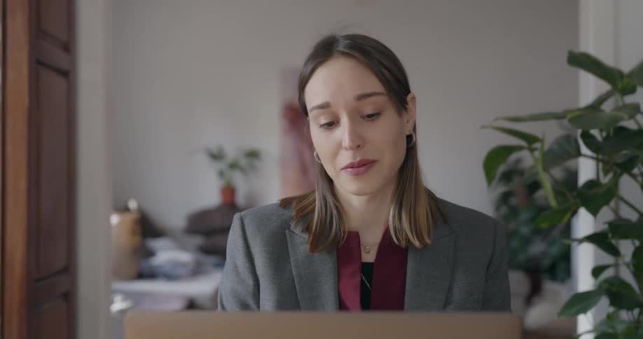 A woman is talking to someone on a laptop