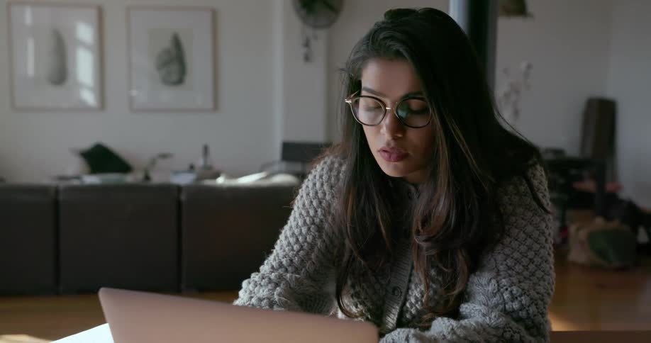 Woman types on a laptop