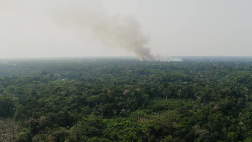 Aerial footage of a wildfire in the distance