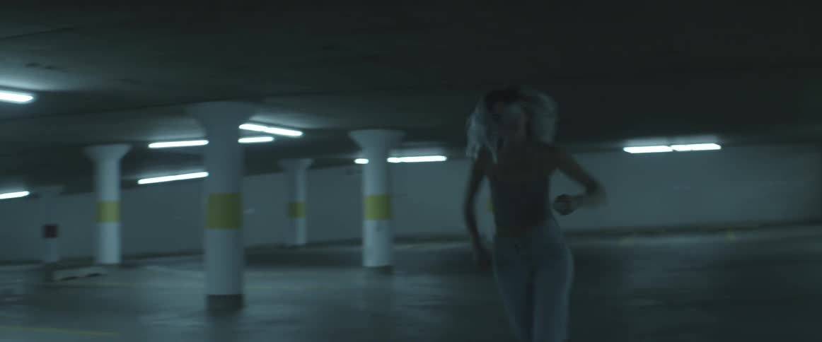 People running through a parking garage