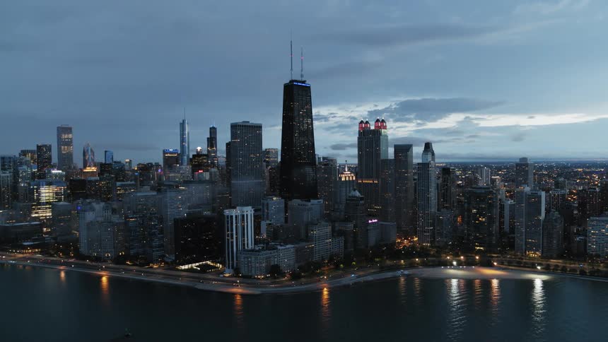 Lights along Chicago skyline as day turns to night