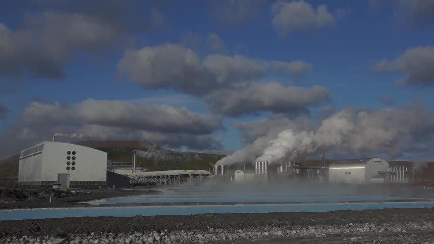 Dense smoke rises from chimneys at a factory