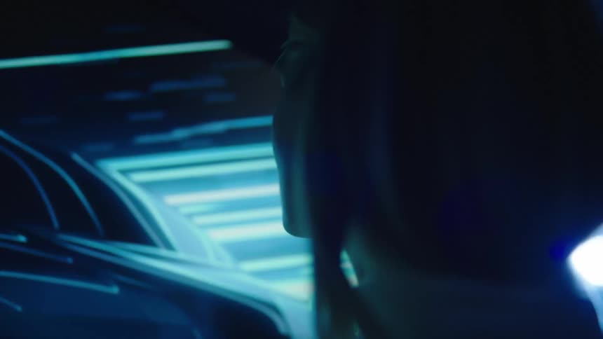 Two people are watching a television screen