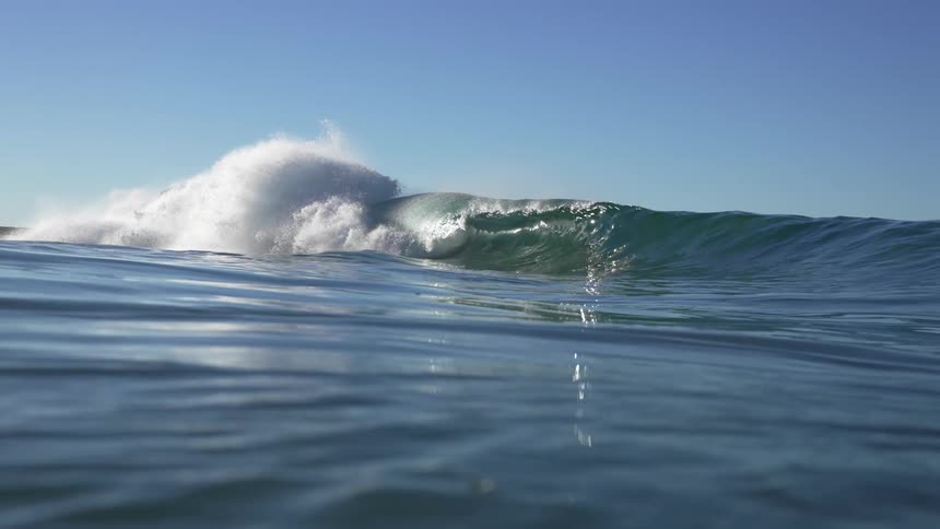Ocean wave breaks against the shore