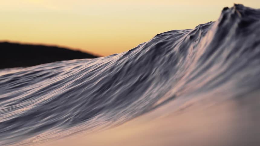 Ocean waves are moving in the sea at dusk