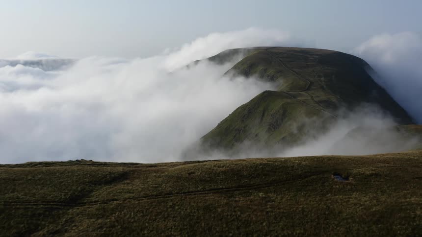 Dense clouds surround the peaks on the mountain range