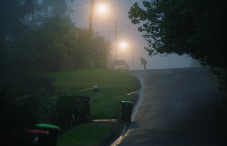 A person is running down a street at night