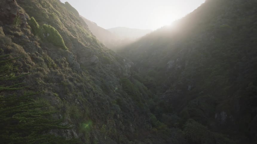 Valley between high mountains at sunset