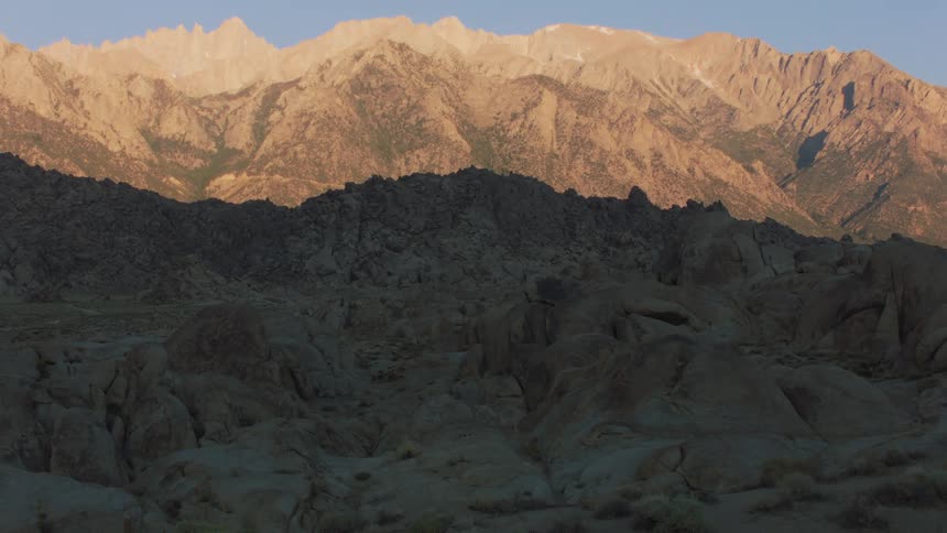 The sun shining down on a mountain range