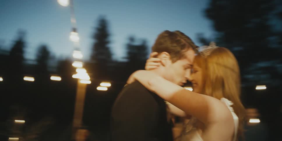 A bride and groom dance at an outdoor wedding reception