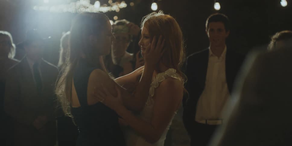 A bride hugs her mom at a wedding reception