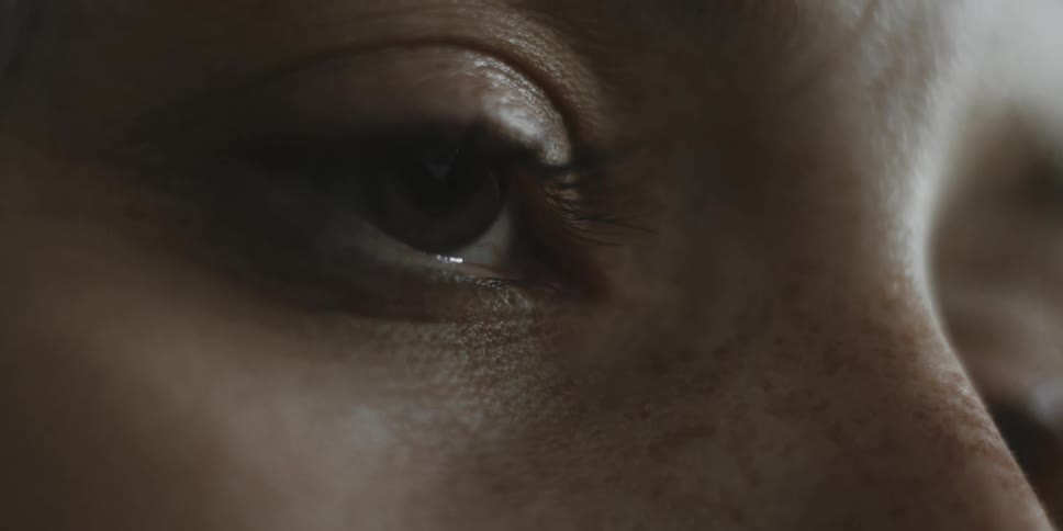 A person blinks their eye slowly