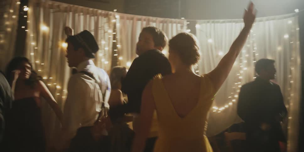 A couple dance vigorously at a prom