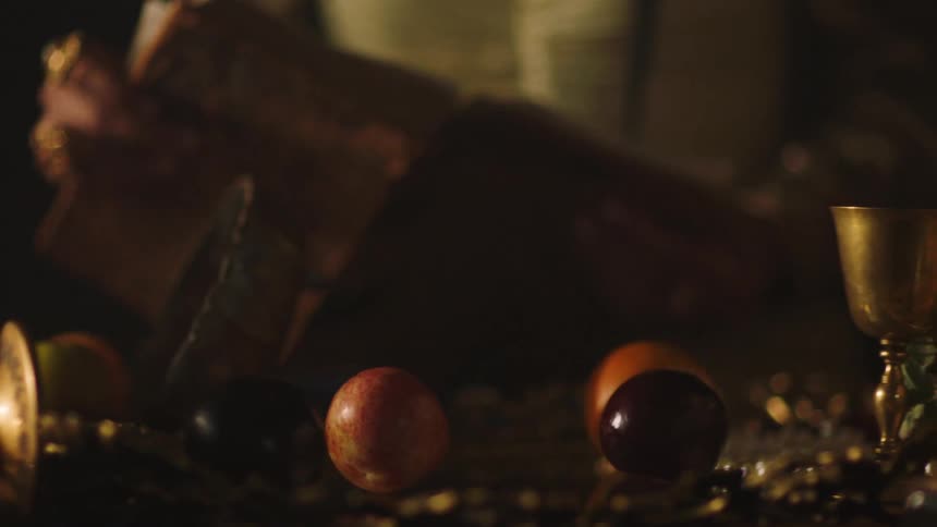 Fruit is falling out of a bowl on a table