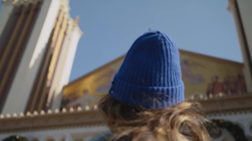 A woman looks up at the church