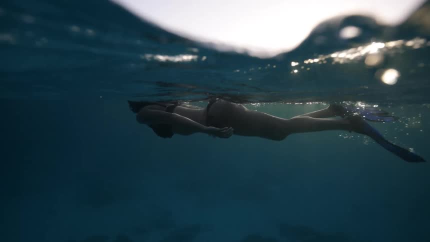 A woman is snorkeling in the ocean