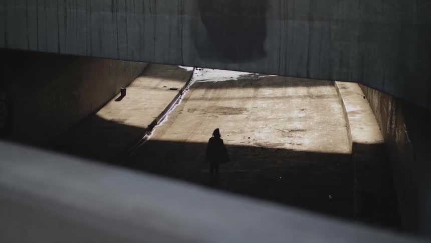 A person is walking into an empty building