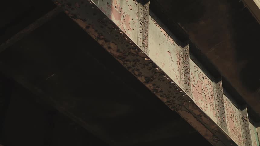 The metal entrance to a tunnel is rusted