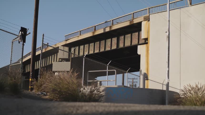 Bridge passes near razor topped chainlink fence