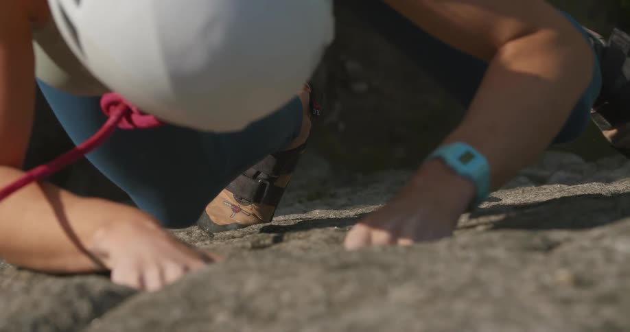A woman is rock climbing