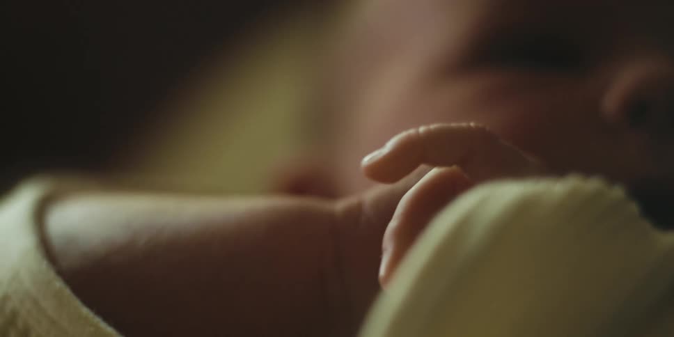 A baby is moving his small hands