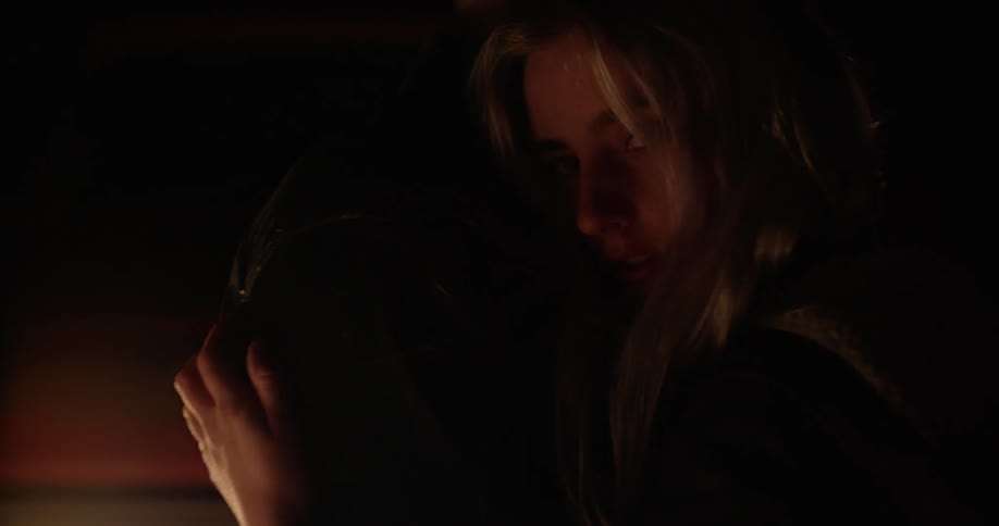 Couple embracing next to a campfire