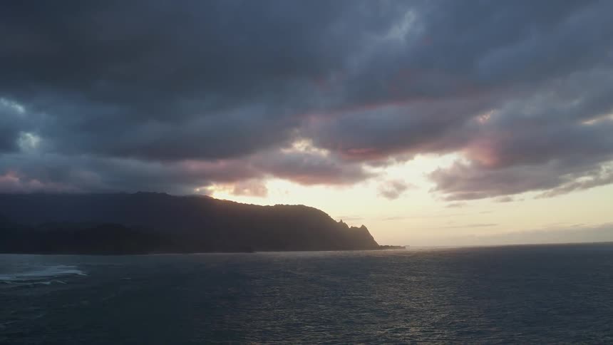 Dark clouds hovering above a mountainous beach area