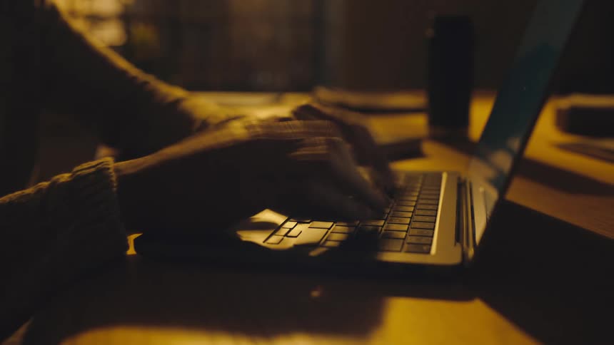 timelapse of hands typing on laptop keyboard