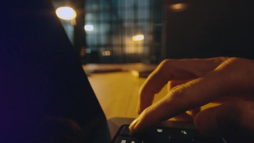 camera flies through laptop opening and hand pressing key to turn on screen