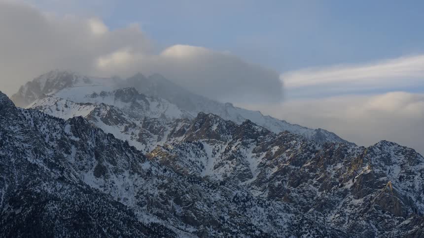 White clouds and blue sky over the snowy mountains