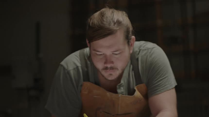 A man sketches on a work table