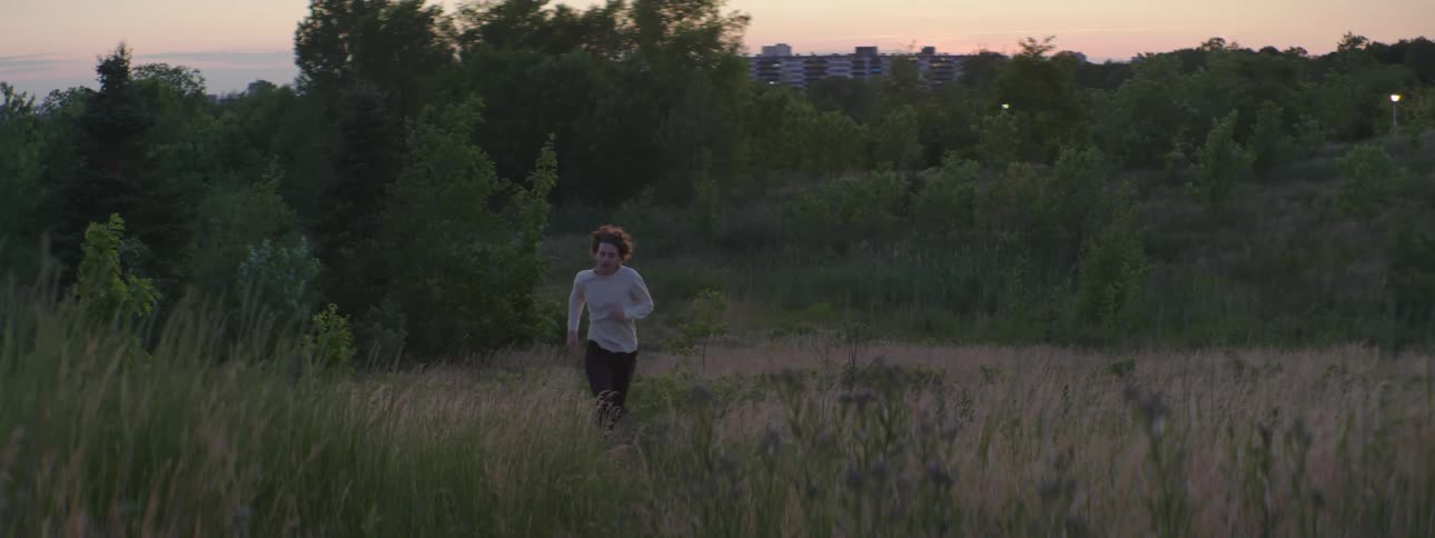 A man running outdoors in a field