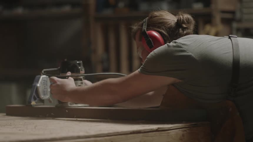 Man using a power tool in a workshop