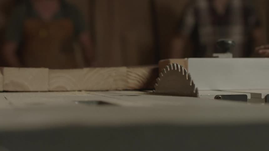 Wooden planks sit on a circular saw table