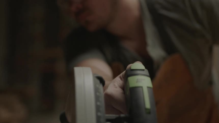 Man using a power saw in his shop