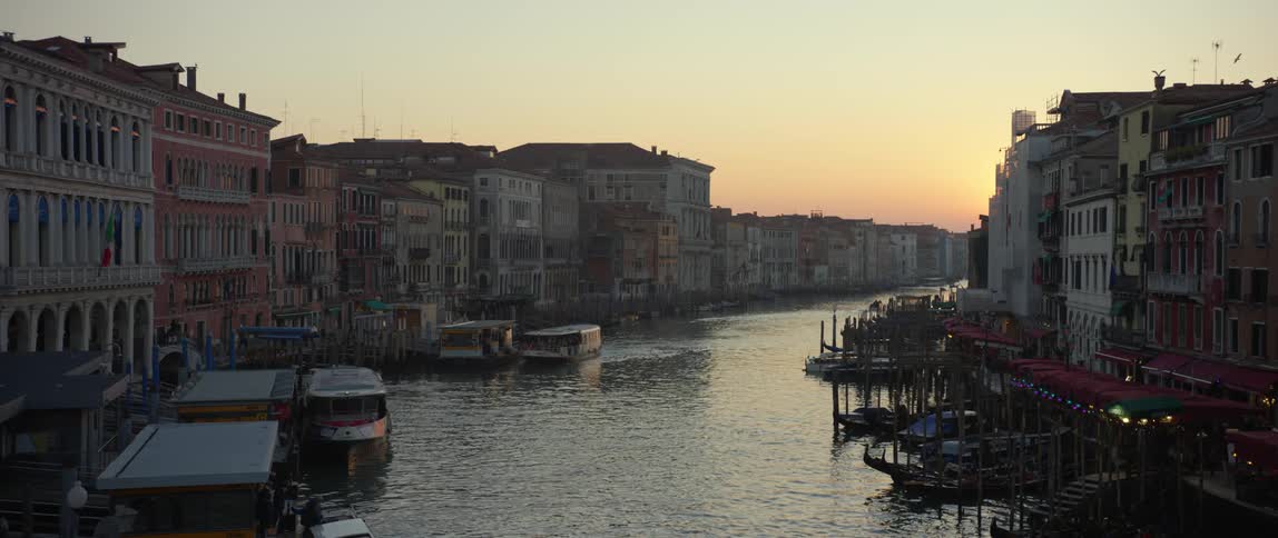 View of palazzos and boats down the Grand Canal in Venice, Italy at sunset