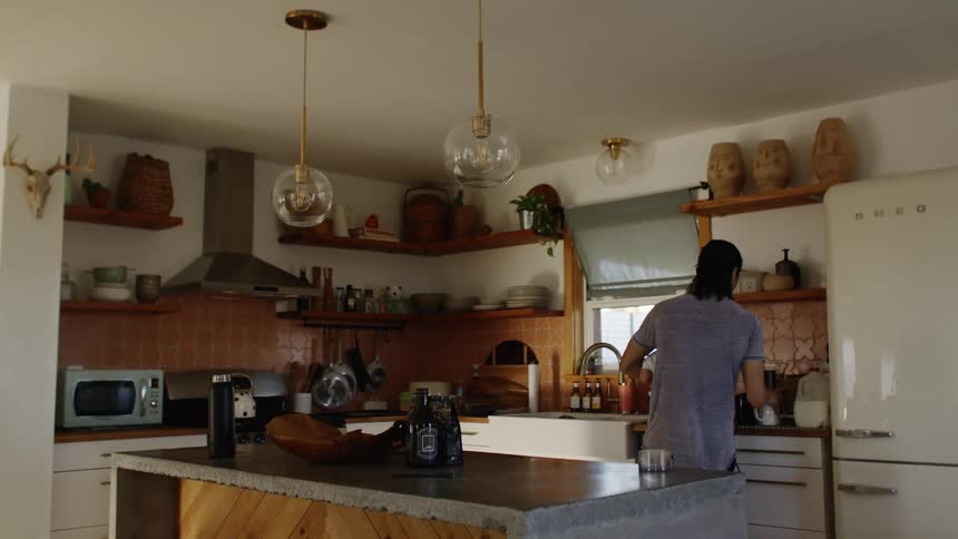 A man prepares coffee in his kitchen