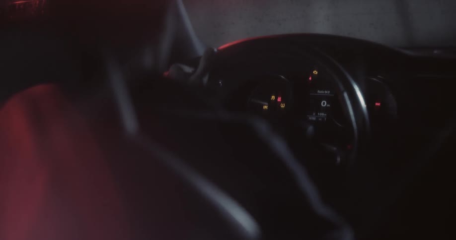 Person getting into the driver's seat as seen from the backseat