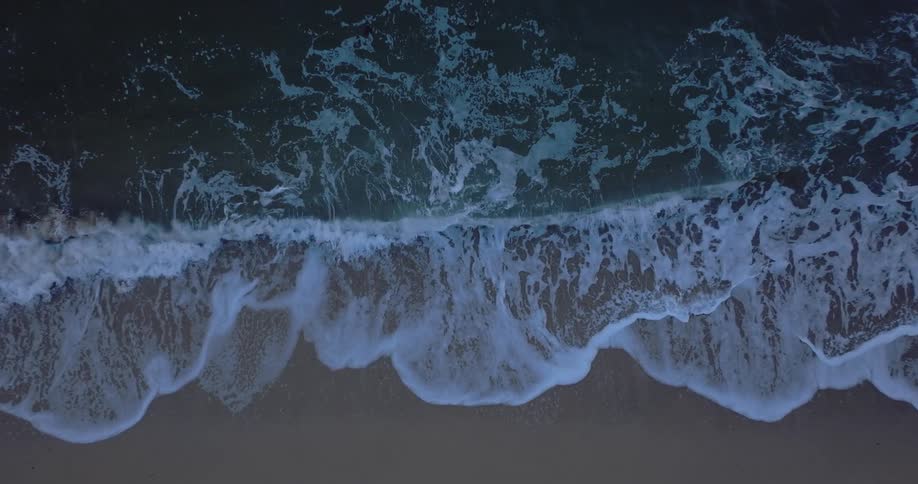 Ocean waves washing onto a sandy beach