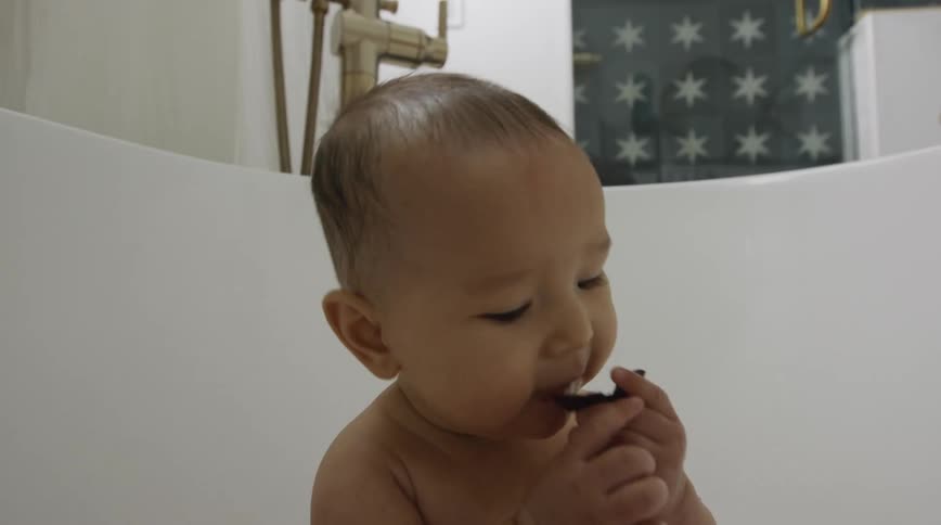 A mother is bathing her child