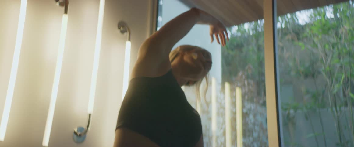 A woman is doing yoga at home